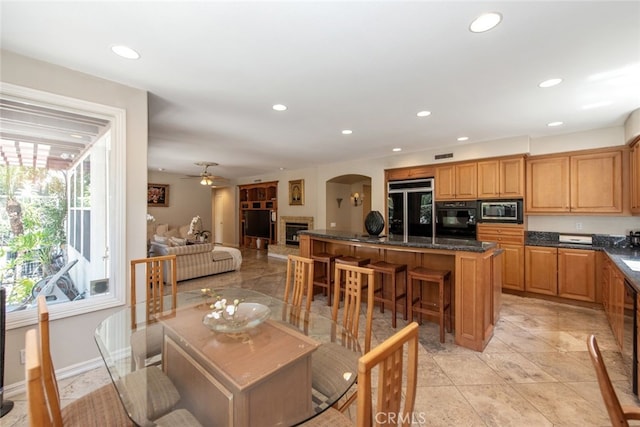 2 Shadow, Irvine, CA 92620 - dining space featuring arched walkways, recessed lighting, a fireplace, and a ceiling fan