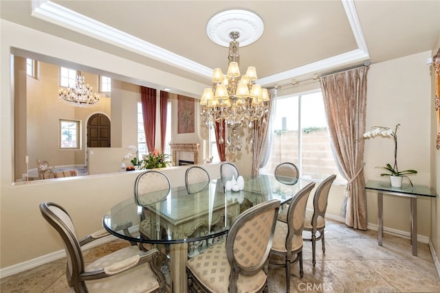 2 Shadow, Irvine, CA 92620 - dining space featuring a chandelier, a raised ceiling, crown molding, and a fireplace