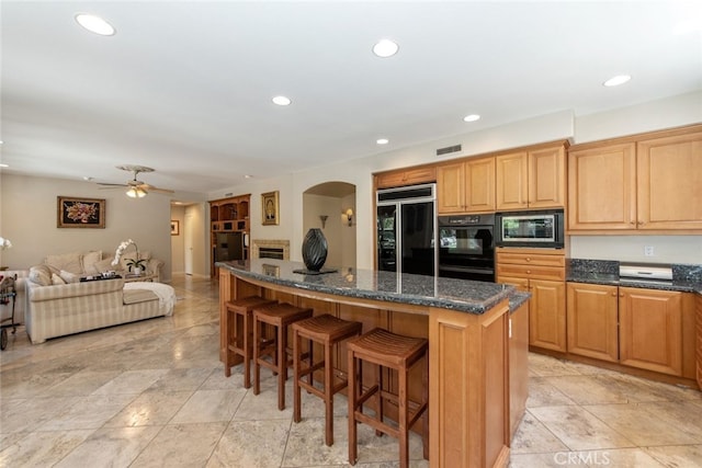 2 Shadow, Irvine, CA 92620 - kitchen with black fridge, stainless steel microwave, a kitchen island, a kitchen bar, and open floor plan