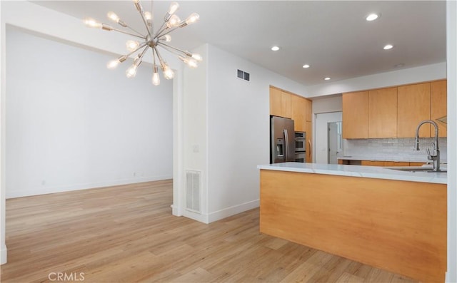 3 Longbourn Aisle, Irvine, CA 92603 - kitchen with a chandelier, stainless steel fridge with ice dispenser, recessed lighting, light wood finished floors, and decorative backsplash