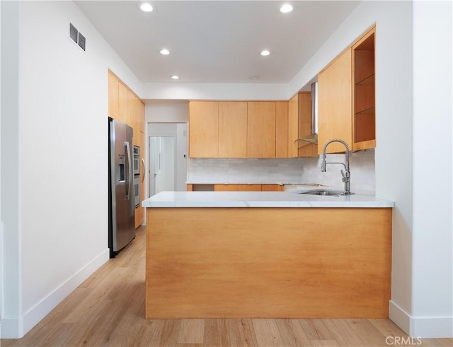 3 Longbourn Aisle, Irvine, CA 92603 - kitchen with stainless steel refrigerator with ice dispenser, a peninsula, light countertops, light wood finished floors, and recessed lighting