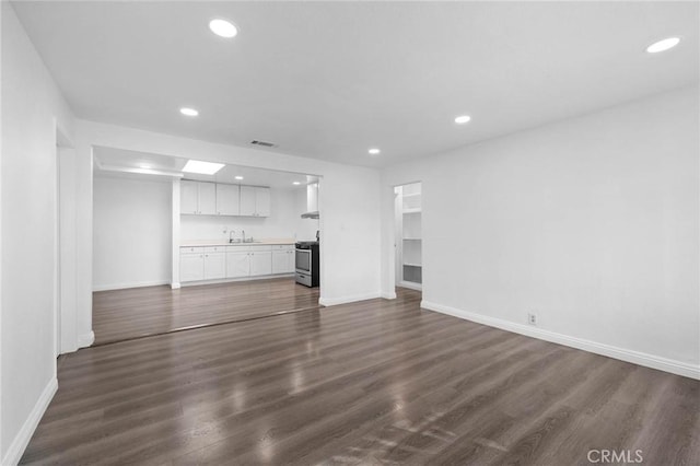 3310 Mangum St, Baldwin Park, CA 91706 - unfurnished living room with recessed lighting, dark wood-type flooring, and wet bar
