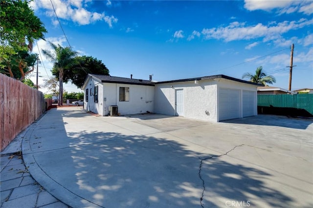 3310 Mangum St, Baldwin Park, CA 91706 - back of house featuring stucco siding, concrete driveway, and an attached garage