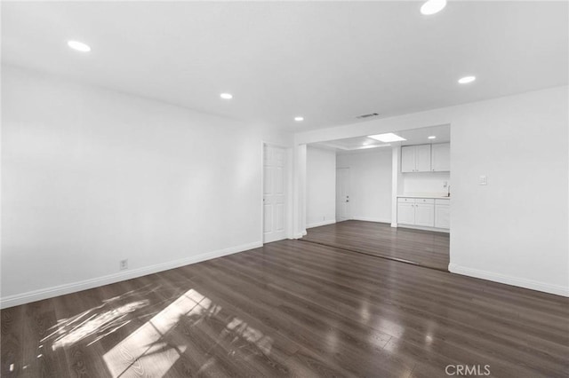 3310 Mangum St, Baldwin Park, CA 91706 - unfurnished living room with dark wood-type flooring and recessed lighting
