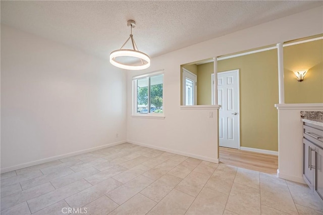 2601 Hoover Ct, Merced, CA 95340 - unfurnished dining area with light tile patterned floors and a textured ceiling