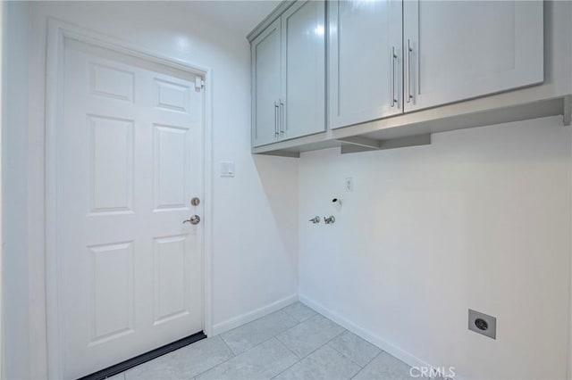 2601 Hoover Ct, Merced, CA 95340 - laundry area with hookup for an electric dryer, cabinet space, and light tile patterned floors