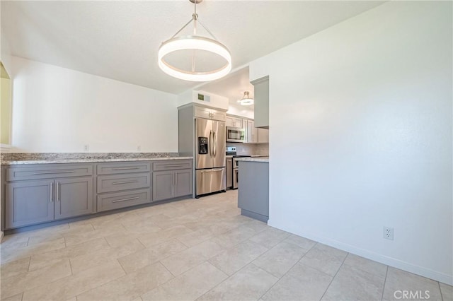 2601 Hoover Ct, Merced, CA 95340 - kitchen with stainless steel appliances, gray cabinets, light countertops, and pendant lighting