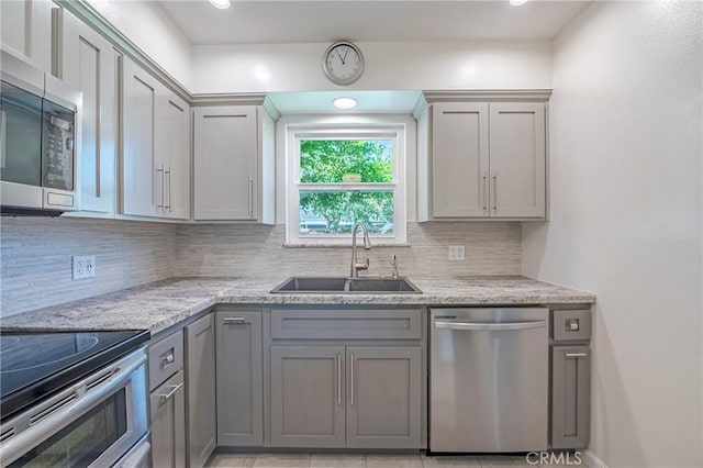 2601 Hoover Ct, Merced, CA 95340 - kitchen with appliances with stainless steel finishes, gray cabinets, tasteful backsplash, light stone countertops, and recessed lighting