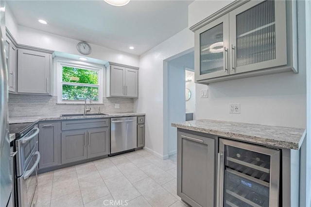2601 Hoover Ct, Merced, CA 95340 - kitchen featuring stainless steel appliances, beverage cooler, gray cabinetry, decorative backsplash, and recessed lighting