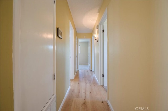 2601 Hoover Ct, Merced, CA 95340 - corridor with light wood-type flooring and baseboards