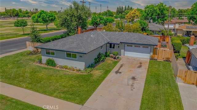 2601 Hoover Ct, Merced, CA 95340 - view of front of home featuring roof with shingles, concrete driveway, stucco siding, an attached garage, and a chimney