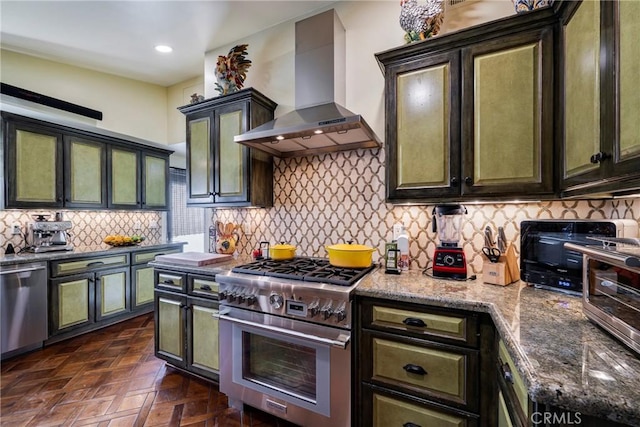 5837 Los Arcos Way, Buena Park, CA 90620 - kitchen with wall chimney exhaust hood, appliances with stainless steel finishes, green cabinetry, decorative backsplash, and light stone counters