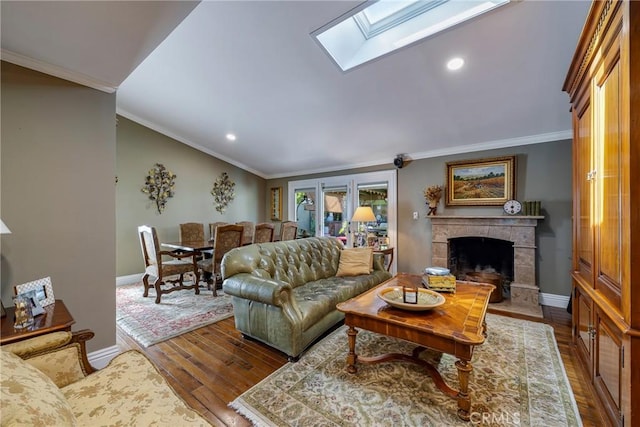 5837 Los Arcos Way, Buena Park, CA 90620 - living room featuring a skylight, wood finished floors, a fireplace, lofted ceiling, and crown molding