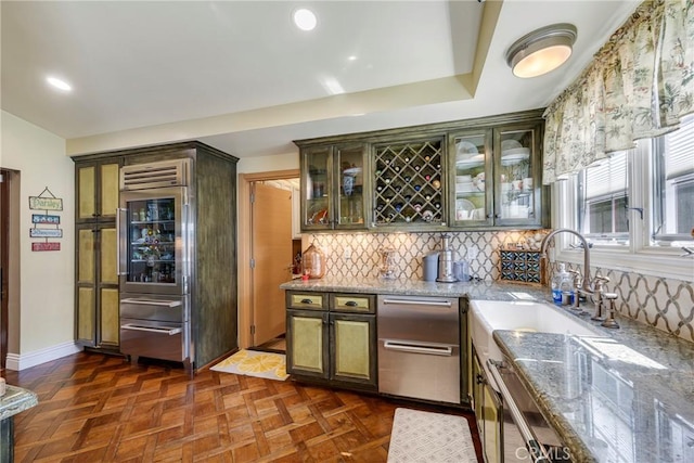 5837 Los Arcos Way, Buena Park, CA 90620 - kitchen with built in fridge, backsplash, light stone countertops, glass insert cabinets, and recessed lighting
