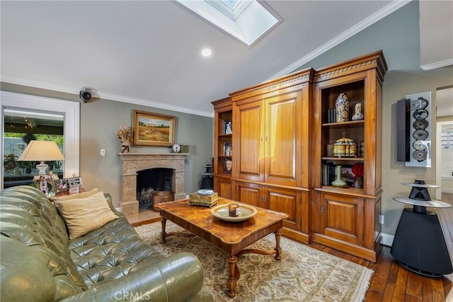 5837 Los Arcos Way, Buena Park, CA 90620 - living area featuring a skylight, dark wood-style flooring, a fireplace with flush hearth, crown molding, and recessed lighting