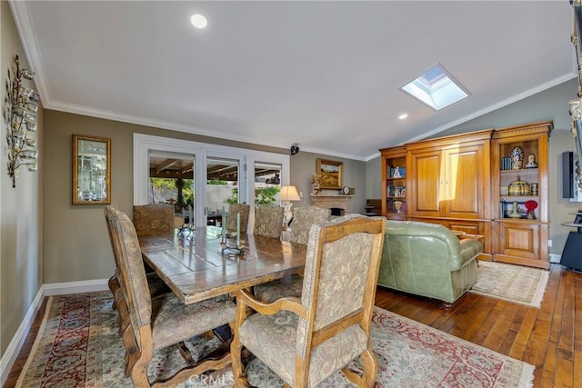 5837 Los Arcos Way, Buena Park, CA 90620 - dining area featuring a skylight, vaulted ceiling, dark wood-style flooring, ornamental molding, and a fireplace