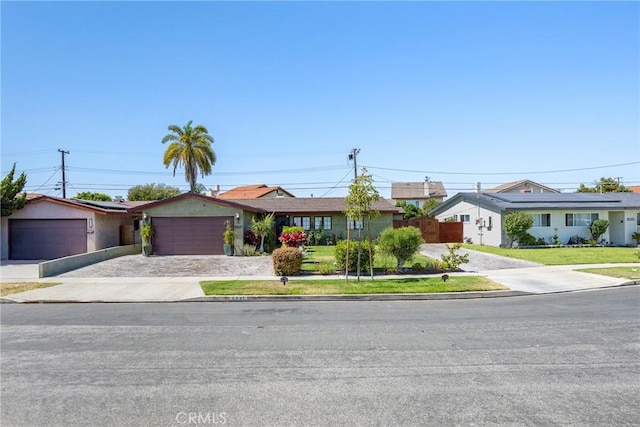 5837 Los Arcos Way, Buena Park, CA 90620 - ranch-style house with driveway, an attached garage, and a residential view