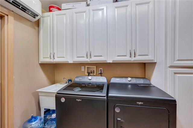 5837 Los Arcos Way, Buena Park, CA 90620 - laundry room featuring an AC wall unit, independent washer and dryer, and cabinet space
