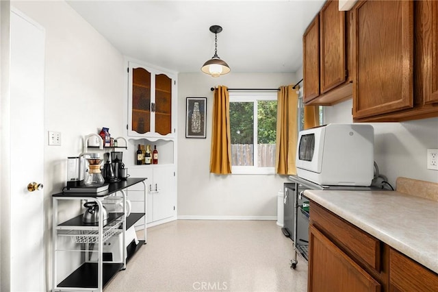 886 Lynn Ln, Chico, CA 95926 - kitchen featuring brown cabinets, light countertops, and pendant lighting