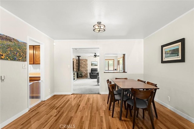 886 Lynn Ln, Chico, CA 95926 - dining room with a wood stove, light wood-style floors, and crown molding