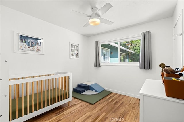 886 Lynn Ln, Chico, CA 95926 - bedroom with light wood-type flooring, a nursery area, and ceiling fan