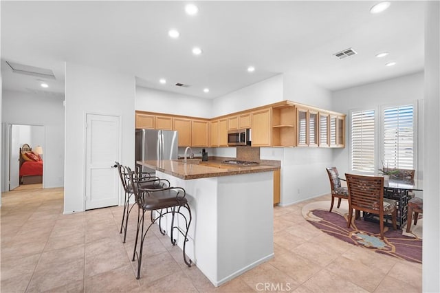 44397 Mesquite Dr, Indian Wells, CA 92210 - kitchen with appliances with stainless steel finishes, open shelves, light brown cabinetry, an island with sink, and recessed lighting