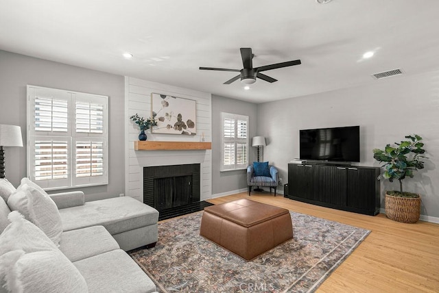 8213 Strub Ave, Whittier, CA 90602 - living room with a large fireplace, ceiling fan, wood finished floors, and recessed lighting