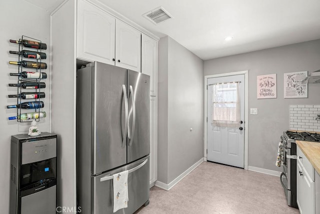 8213 Strub Ave, Whittier, CA 90602 - kitchen with appliances with stainless steel finishes, white cabinets, light carpet, and recessed lighting