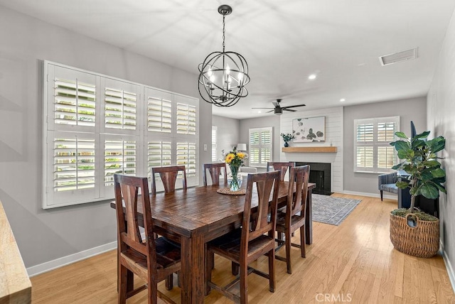 8213 Strub Ave, Whittier, CA 90602 - dining room with a ceiling fan, light wood-style flooring, a brick fireplace, recessed lighting, and a chandelier