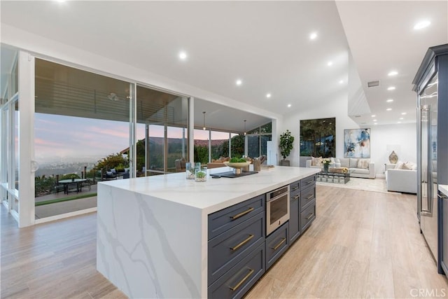 952 Via Del Monte, Palos Verdes Estates, CA 90274 - kitchen with light wood-type flooring, open floor plan, light stone counters, a center island, and recessed lighting