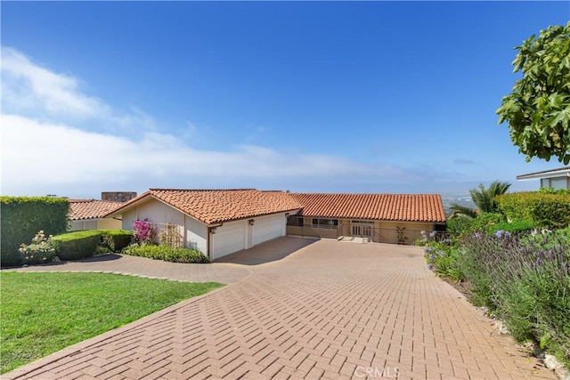 952 Via Del Monte, Palos Verdes Estates, CA 90274 - mediterranean / spanish house featuring a tiled roof, a garage, driveway, a front yard, and stucco siding