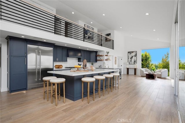 952 Via Del Monte, Palos Verdes Estates, CA 90274 - kitchen featuring built in refrigerator, open shelves, high vaulted ceiling, light countertops, and a kitchen breakfast bar