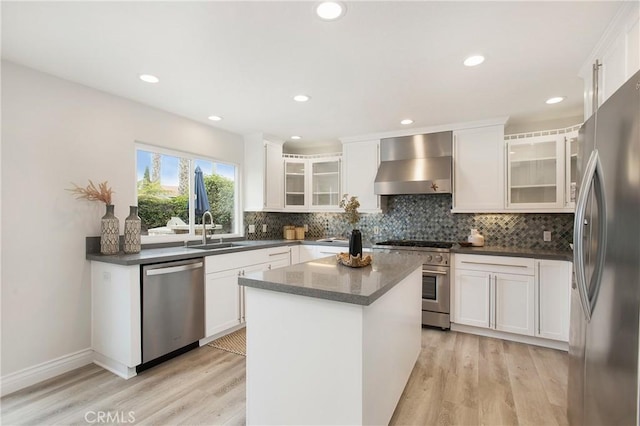 9552 Castine Dr, Huntington Beach, CA 92646 - kitchen featuring stainless steel appliances, wall chimney range hood, dark countertops, light wood finished floors, and recessed lighting