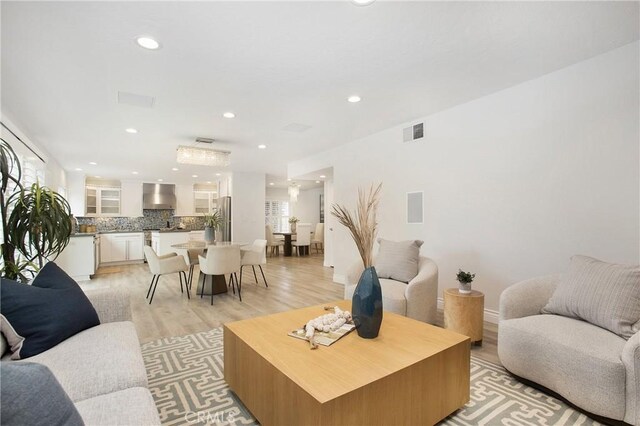 9552 Castine Dr, Huntington Beach, CA 92646 - living room featuring light wood-type flooring and recessed lighting