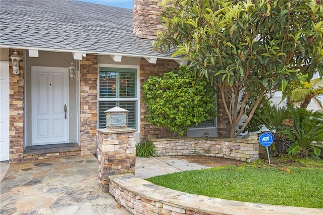 9552 Castine Dr, Huntington Beach, CA 92646 - property entrance with a shingled roof, a chimney, and stone siding