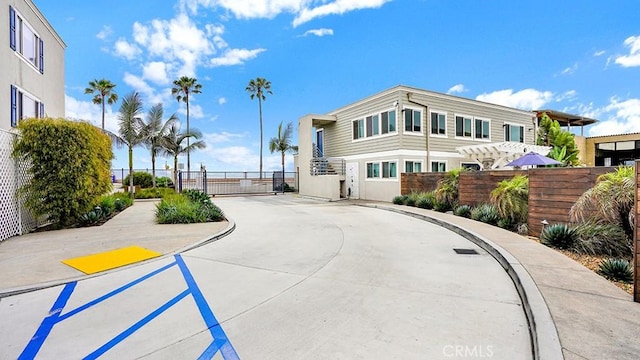 1202 N Pacific St Unit 203A, Oceanside, CA 92054 - view of concrete road featuring a gate, curbs, and sidewalks