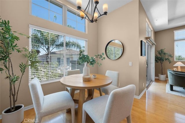 18051 Joyful Ln Unit 201, Huntington Beach, CA 92648 - dining space featuring light wood finished floors and a chandelier