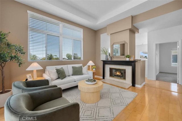 18051 Joyful Ln Unit 201, Huntington Beach, CA 92648 - living area featuring light wood finished floors, plenty of natural light, and a tiled fireplace