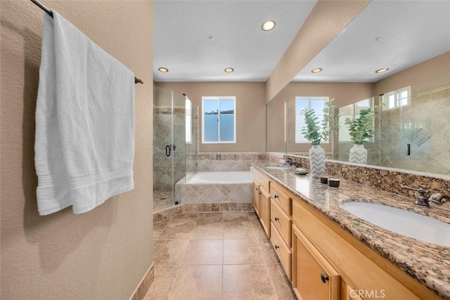 18051 Joyful Ln Unit 201, Huntington Beach, CA 92648 - bathroom with a garden tub, double vanity, recessed lighting, a stall shower, and tile patterned flooring