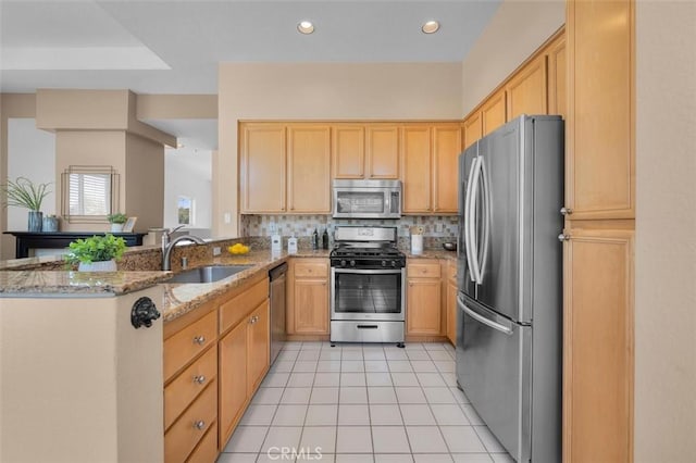 18051 Joyful Ln Unit 201, Huntington Beach, CA 92648 - kitchen featuring stainless steel appliances, light tile patterned floors, light brown cabinetry, light stone countertops, and backsplash