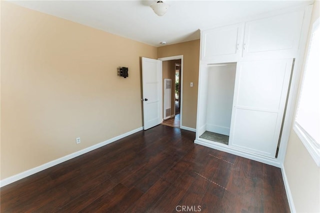 902 E Francis Ave, La Habra, CA 90631 - unfurnished bedroom featuring dark wood-style flooring, a closet, and multiple windows