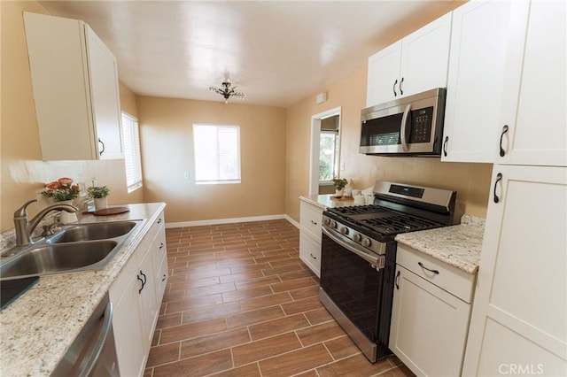 902 E Francis Ave, La Habra, CA 90631 - kitchen with appliances with stainless steel finishes, wood finished floors, and white cabinets