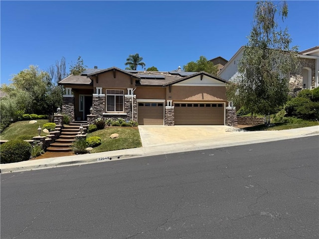 22045 Milestone St, Saugus, CA 91390 - view of front of property with stucco siding, an attached garage, stone siding, roof mounted solar panels, and driveway