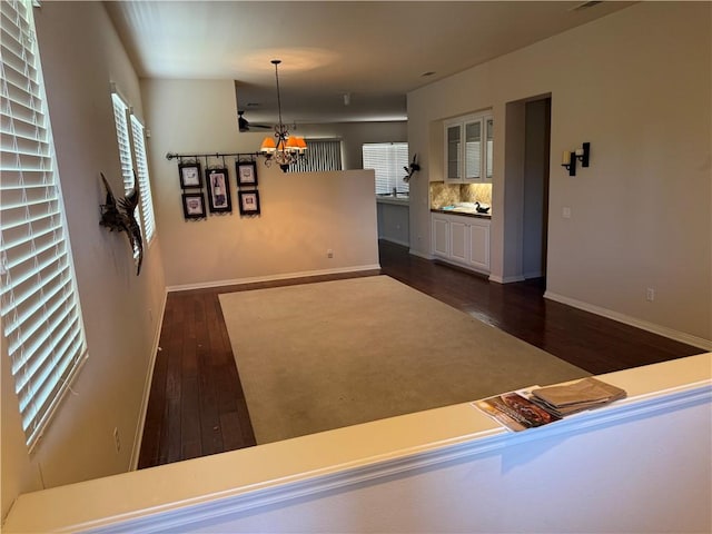 22045 Milestone St, Saugus, CA 91390 - unfurnished living room with dark wood-type flooring and a chandelier