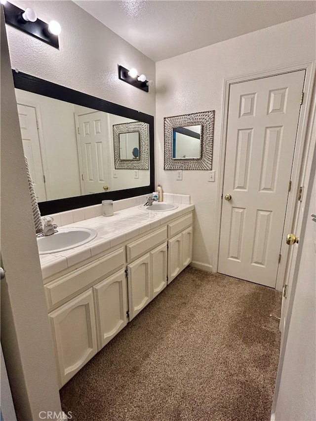 42445 Deep Forest Dr, Coarsegold, CA 93614 - full bathroom featuring carpet flooring, double vanity, a textured wall, and a textured ceiling