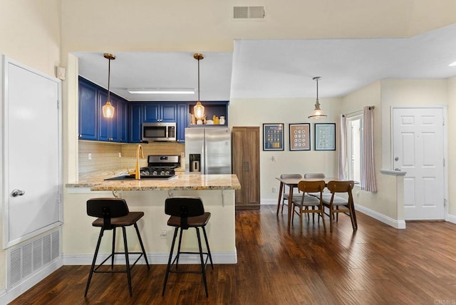 340 Isthmus Way Unit 56, Oceanside, CA 92058 - kitchen with appliances with stainless steel finishes, blue cabinets, a peninsula, tasteful backsplash, and dark wood finished floors