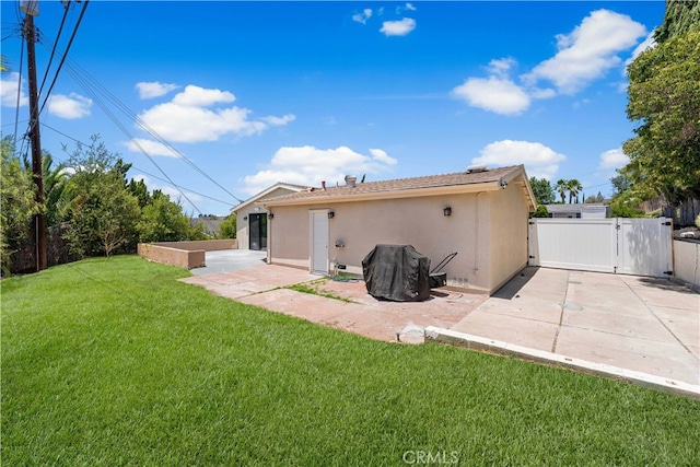 18718 Delight St, Canyon Country, CA 91351 - rear view of house featuring stucco siding, a patio area, and a gate