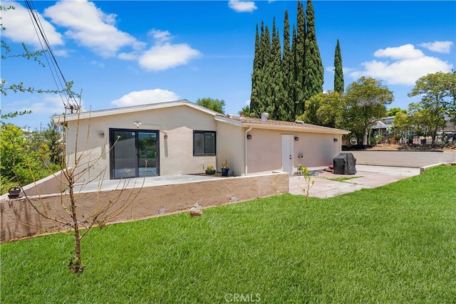 18718 Delight St, Canyon Country, CA 91351 - rear view of house with stucco siding, a lawn, and a patio
