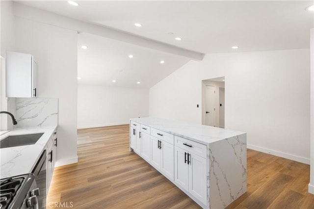 18718 Delight St, Canyon Country, CA 91351 - kitchen featuring light wood finished floors, gas range oven, a center island, white cabinetry, and recessed lighting