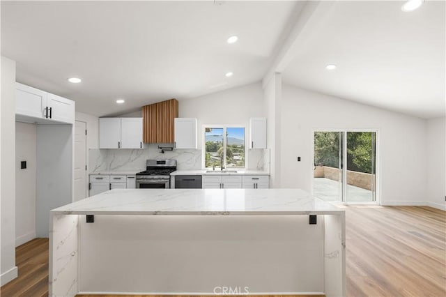 18718 Delight St, Canyon Country, CA 91351 - kitchen with appliances with stainless steel finishes, light wood-style flooring, backsplash, white cabinets, and light stone countertops